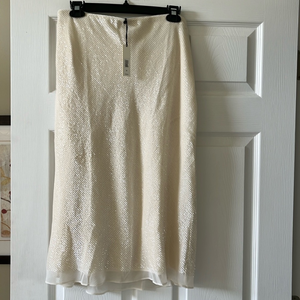 Cream color sequin skirt .. no slit in back.  Side zipper. Brand new
